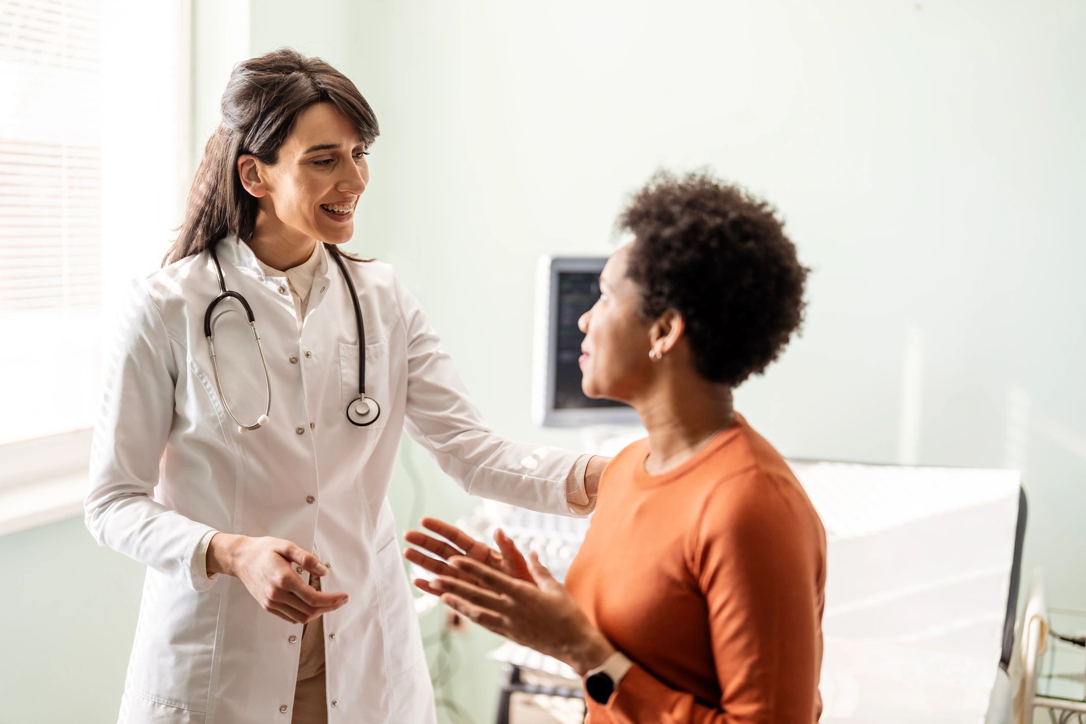 Healthcare staff speaking with a patient about care instructions