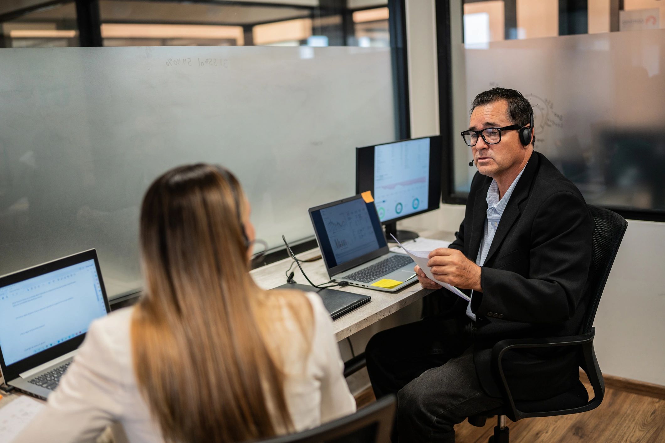 Two coworkers talking in a workplace setting