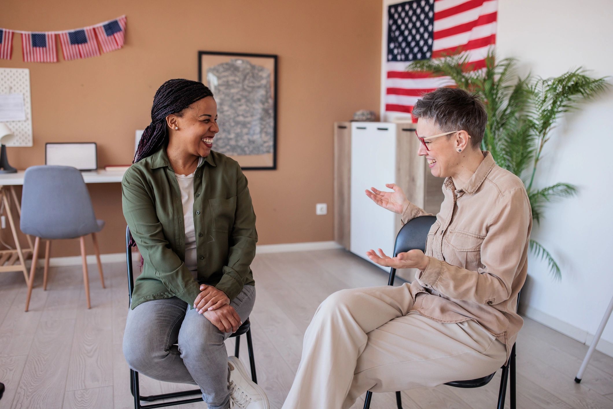 Army veteran speaking with a friend in a meeting room